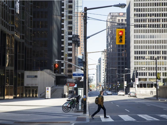 A pedestrian crosses bay street in Toronto